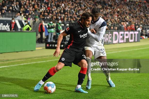 Goncalo Paciencia of Eintracht Frankfurt is tackled by Armel Bella Kotchap of VfL Bochum during the Bundesliga match between Eintracht Frankfurt and...