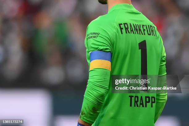 Kevin Trapp of Eintracht Frankfurt is seen wearing a captain`s armband in Ukraine colors during the Bundesliga match between Eintracht Frankfurt and...