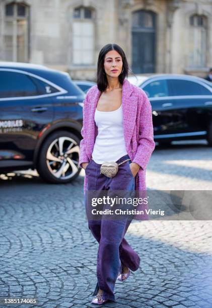 Gilda Ambrosio seen wearing pink coat, purple pants, beige heard shaped micro bag, white top outside Chanel during Paris Fashion Week - Womenswear...