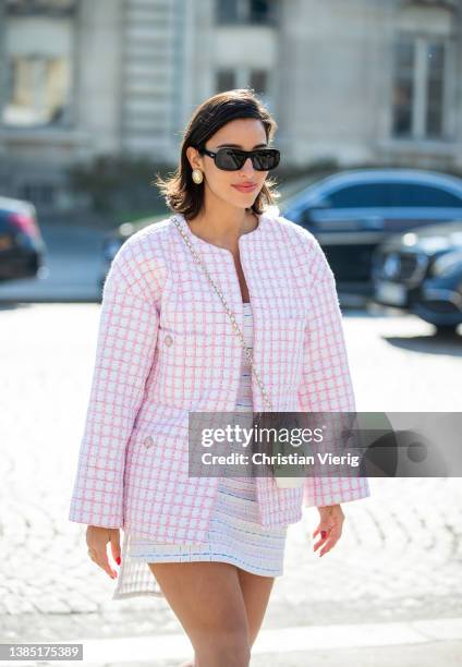 Bettina Looney wearing rose jacket, skirt, white heart shaped bag seen outside Chanel during Paris Fashion Week - Womenswear F/W 2022-2023 on March...