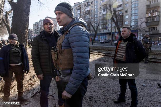 Kyiv's mayor Vitaliy Klitschko surveys the scene of a residential apartment block that was damaged after a Russian rocket was shot down by Ukrainian...