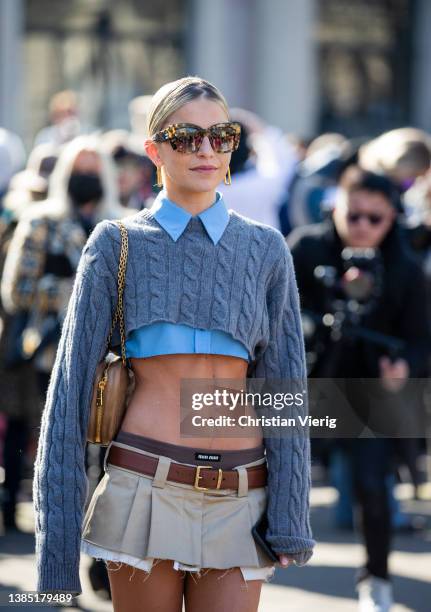 Caroline Caro Daur seen wearing cropped blue button shirt, knit, mini skirt in beige, bag, knee high socks, loafers outside Miu Miu during Paris...