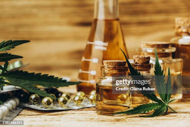 cannabis, cbd softgels, pills and hemp oil. - cannabis dispensary stock pictures, royalty-free photos & images