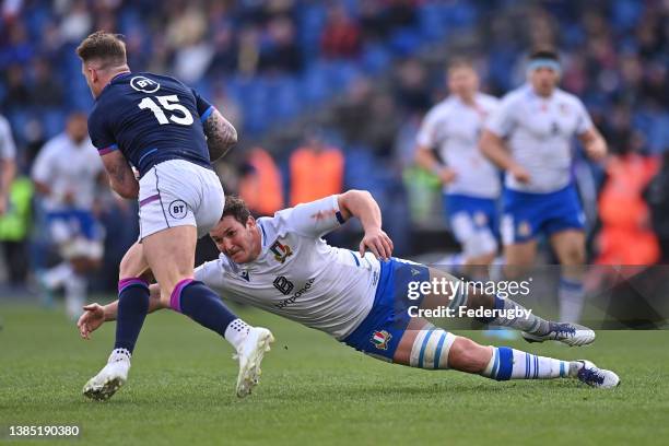 Michele Lamaro of Italy tackles Stuard Hogg of Scotland during the Guinness Six Nations Rugby match between Italy and Scotland at Stadio Olimpico on...