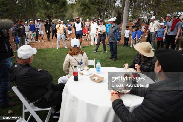 Anirban Lahiri of India prepares to play his second shot on the eighth hole as a gallery of fans look on during the final round of THE PLAYERS...