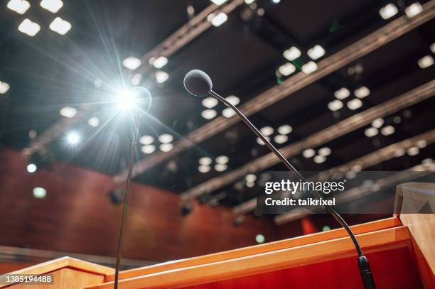 microphones on a lectern in a conference rooms - germany training press conference stock pictures, royalty-free photos & images