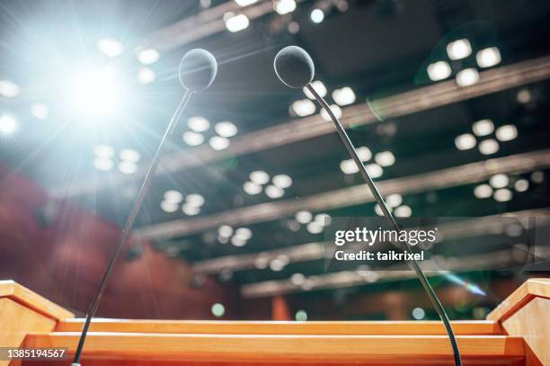 microphones on a lectern in a conference rooms - germany training press conference stock pictures, royalty-free photos & images