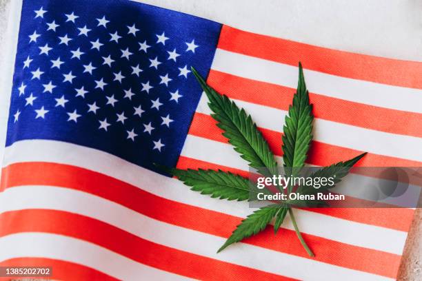 green cannabis leaf over usa flag. - 合法化 ストックフォトと画像