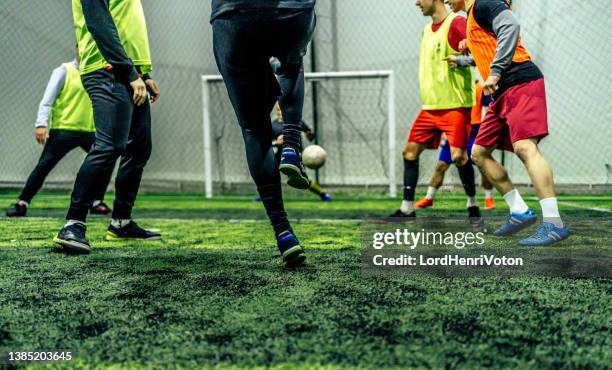 soccer player kicking ball at goal - indoor soccer stock pictures, royalty-free photos & images