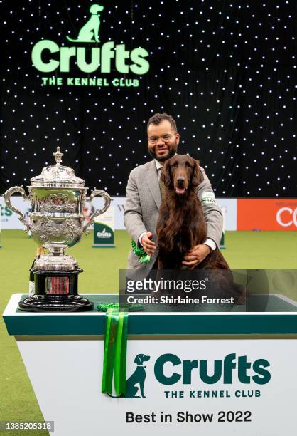 Baxer , a Flat Coat Retriever, with owner Patrick Oware, took home the coveted title Crufts Best in Show champion at National Exhibition Centre on...