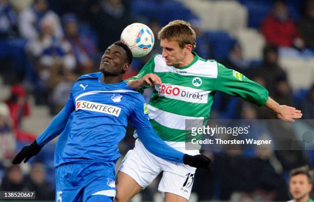 Peniel Mlapa of Hoffenheim battles for the ball with Milorad Pekovic of Fuerth during the DFB Cup Quarter Final match between TSG 1899 Hoffenheim and...