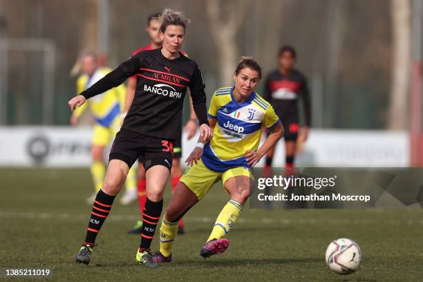 Laura Agard of AC Milan plays the ball as Cristiana Girelli of Juventus closes in during the Women's Coppa Italia Semi Final 1st Leg match at Campo...