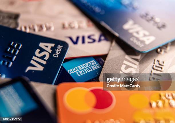 In this photo illustration the Visa, Mastercard and American Express logos are seen on credit and debit cards on March 14, 2022 in Somerset, England....