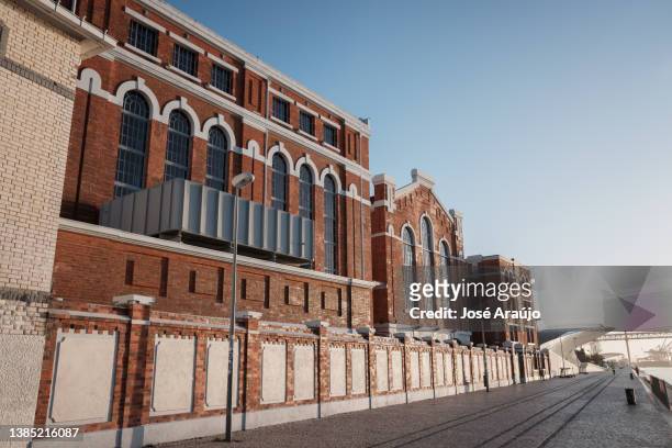 general view of the river-facing side of the electricity museum in lisbon - estrutura construída stock pictures, royalty-free photos & images