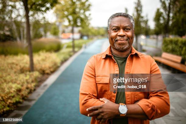 portrait of mature black man outdoor - african american man walking stock pictures, royalty-free photos & images