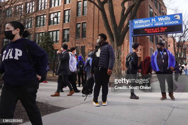 Students leave William Wells High School at the end of the school day on March 14, 2022 in Chicago, Illinois. As COVID-19 cases continue to fall, the...