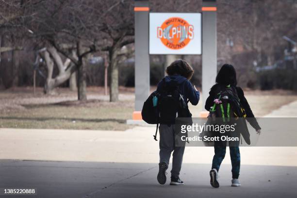 Students leave Whitney Young Magnet High School at the end of the school day on March 14, 2022 in Chicago, Illinois. As COVID-19 cases continue to...