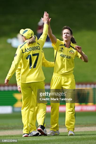 Ellyse Perry of Australia celebrates with Meg Lanning of Australia after taking a wicket during the 2022 ICC Women's Cricket World Cup match between...