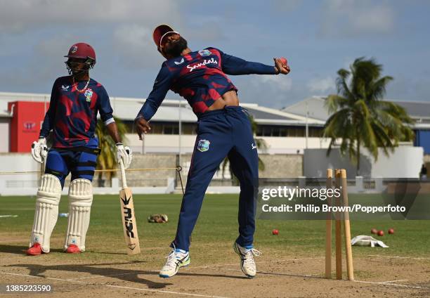 Veerasammy Permaul of West Indies bowls as Kraigg Brathwaite looks on during a training session before the second Test between West Indies and...