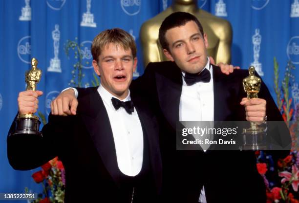 American actor, film producer, and screenwriter, Matt Damon and American actor and filmmaker Ben Affleck celebrate after winning their Oscars for...