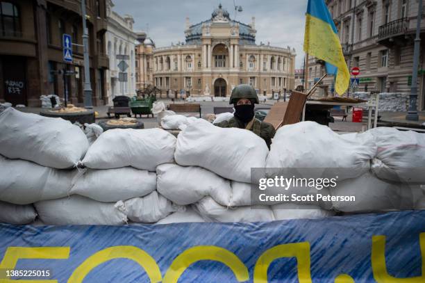 Soldier stands guard over the Odessa Opera and Ballet Theater, as Ukrainians place sandbags and anti-tank barriers to protect historic landmarks in...