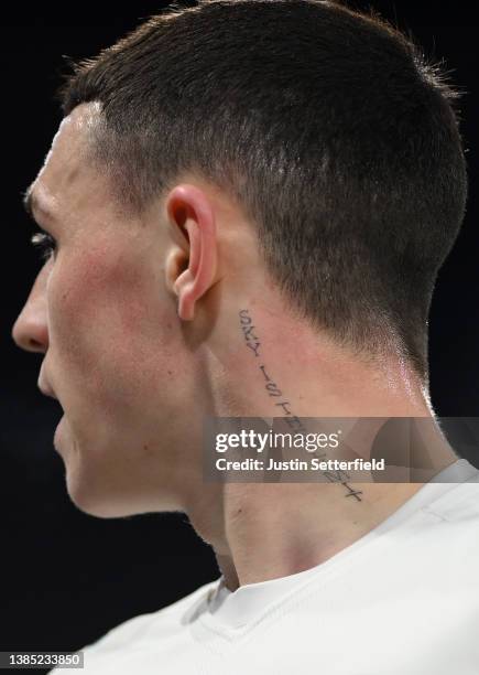 Detailed view of a tattoo on the neck of Phil Foden of Manchester City reading 'sky is the limit' is seen during the Premier League match between...