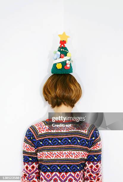 female balancing christmas tree on her head - star on top of tree stock pictures, royalty-free photos & images