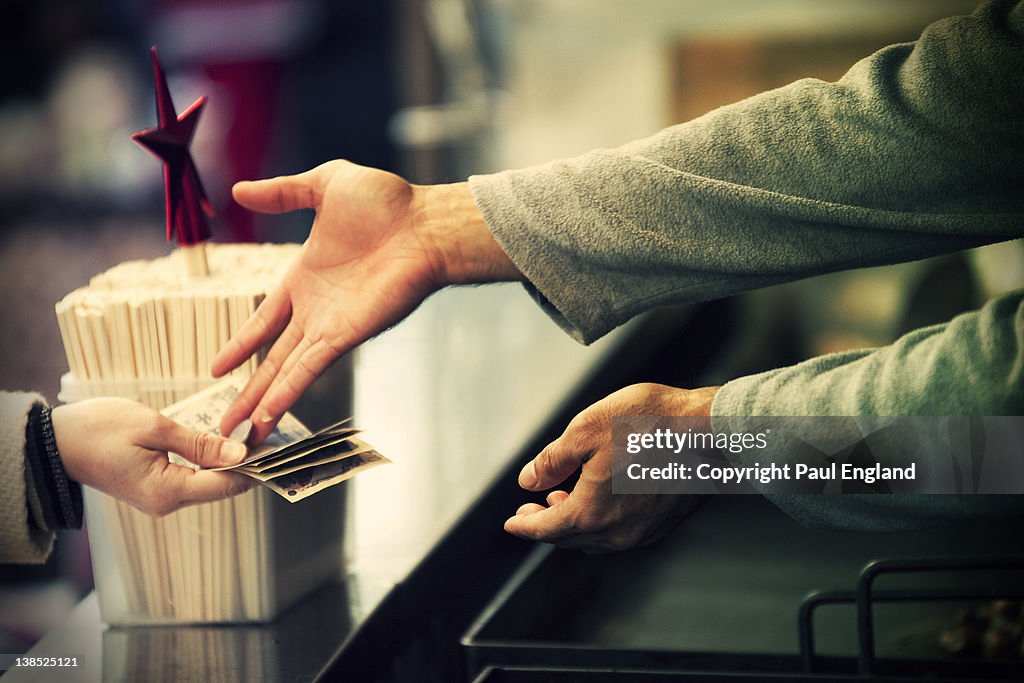 Customer is given change at food stand