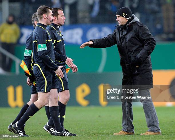 Holger Stanislawski of Hoffenheim shake hands with referee Marco Firitz after the DFB Cup Quarter Final match between TSG 1899 Hoffenheim and SpVgg...