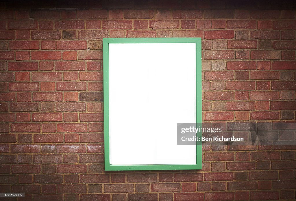 Blank sign on a brick wall
