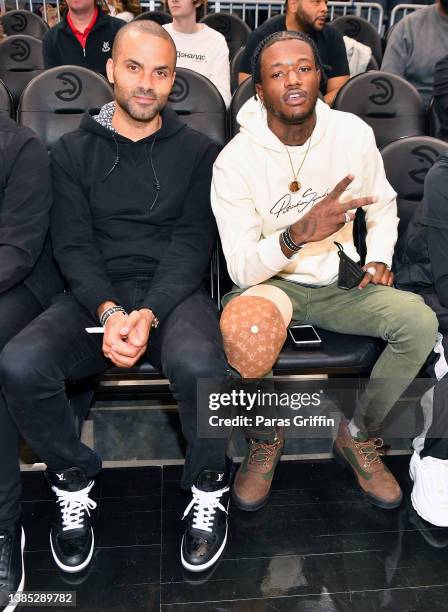 Tony Parker and DC Young Fly attend the game between the Portland Trail Blazers and the Atlanta Hawks at State Farm Arena on March 14, 2022 in...