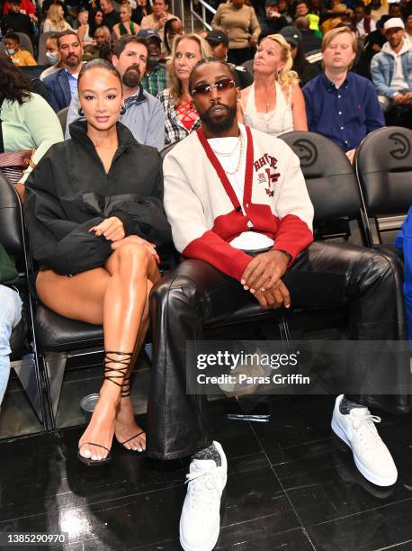 Draya Michele and NFL player Tyrod Taylor attend the game between the Portland Trail Blazers and the Atlanta Hawks at State Farm Arena on March 14,...