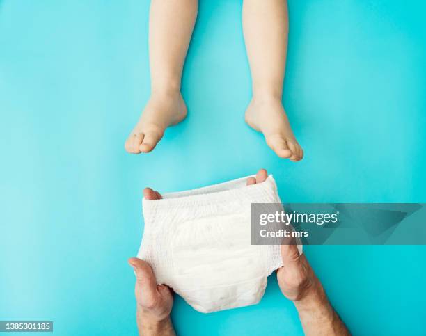 diaper changing - diaper stock pictures, royalty-free photos & images