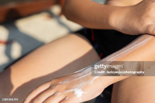 boy with sun shaped sunscreen on his hand - applying stock photos et images de collection