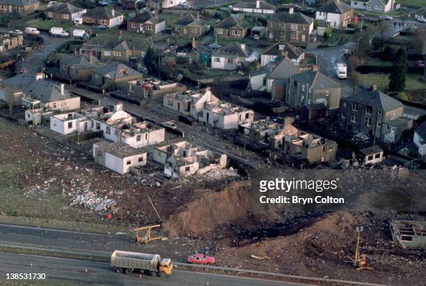 Aircraft debris and destroyed houses in Sherwood Crescent, Lockerbie are seen from the air as traffic passes along the A74 main road following the...