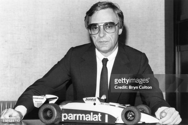 Bernie Ecclestone, owner of the Brabham Grand Prix team, poses for a photograph in his office with a model of a Brabham Grand Prix car at the teams...