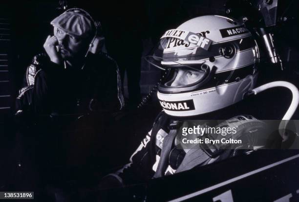 Formula One Grand Prix racing driver Ayrton Senna, driving for Lotus Ð Renault in the 97T John Player Special , sits in the car alongside a mechanic...