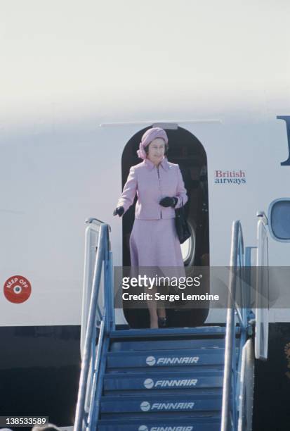 Queen Elizabeth II disembarks from a British Airways flight during her royal tour of New Zealand, 1977.