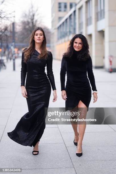 Mariella Ahrens wearing a black longsleeve turtleneck mini dress by Natascha Gruen, black pumps and white chain earrings and matching bracelet by...