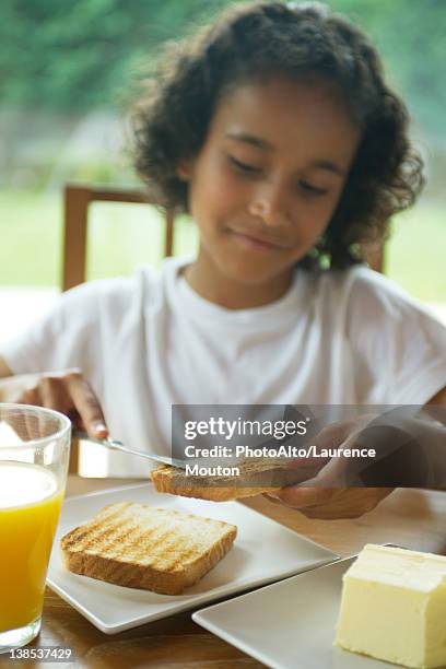 girl buttering toast - buttering stock pictures, royalty-free photos & images