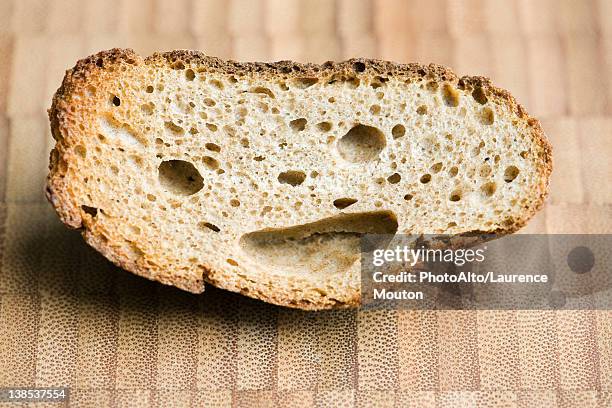 piece of whole wheat bread with smiley face - antropomorfo foto e immagini stock