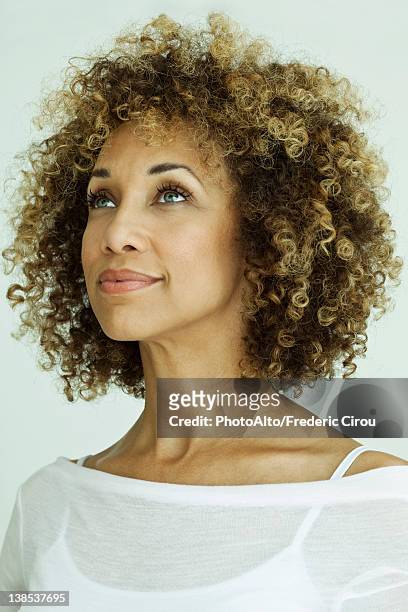 woman looking up optimistically, portrait - three quarter front view ストックフォトと画像