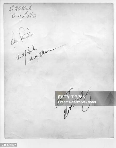 Elvis Presley and members of his first touring band - Bill Black, D.J. Fontana and Scotty Moore - autographed the back of a publicity photograph in...