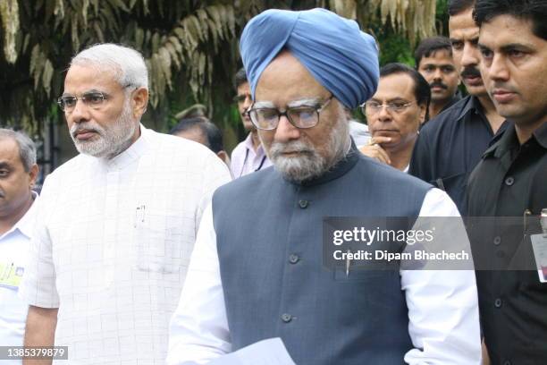 Manmohan Singh, Prime Minister of India, with Narendra Modi then Chief Minister of Gujarat visits L G Hospital in Maninagar Ahmedabad to meet victims...