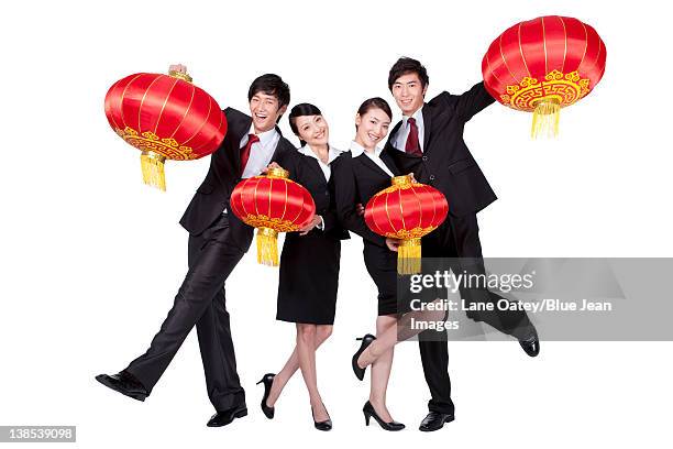 business colleagues holding up chinese lanterns - business woman in red suit jacket stock pictures, royalty-free photos & images