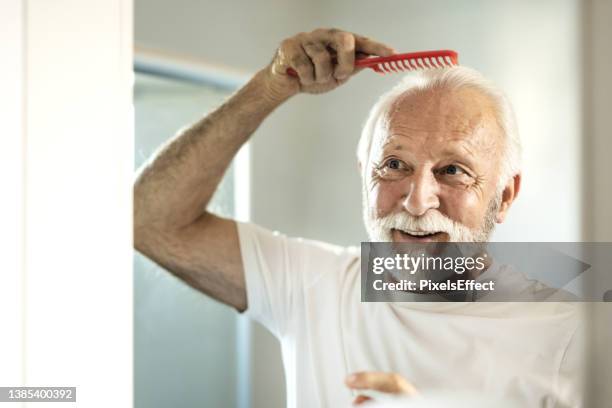 creating a hairstyle - man combing hair stock pictures, royalty-free photos & images