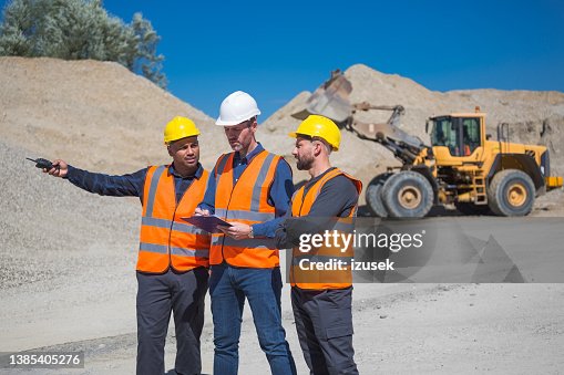 Open-pit mine workers and engineer Open-pit mine workers and engineer
