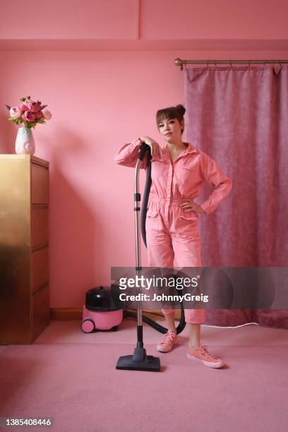 portrait of early 40s woman with vacuum and attitude - eccentric woman stock pictures, royalty-free photos & images