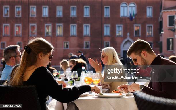 Tourists dine at a restaurant on March 12, 2022 in Venice, Italy. Tourists have gradually begun to return to the city, whose economy relies primarily...