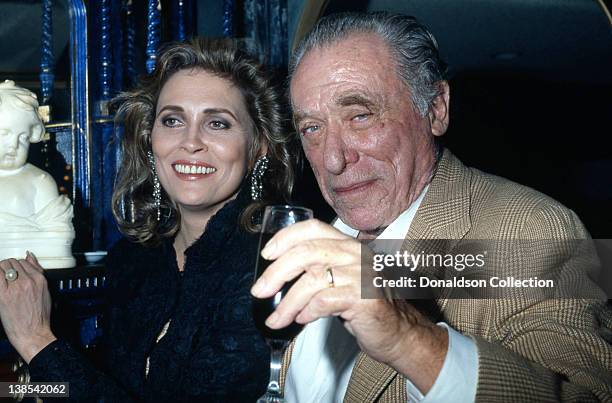 Faye Dunaway and Charles Bukowski attend an event in November 1987 in Los Angeles, California.